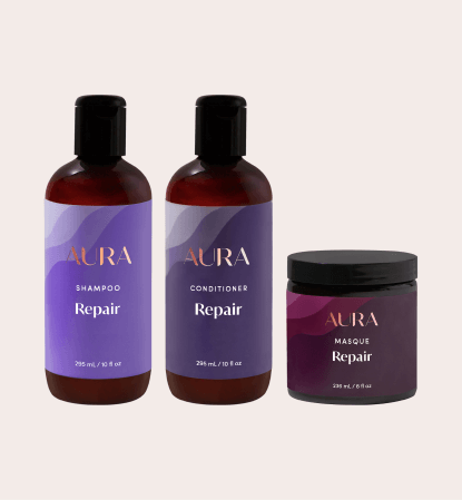 Bottles of Aura Conditioner, Shampoo, and Masque in the Repair Ritual line.