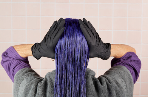 A client showcasing their hair while using an aura neutralizer duo
