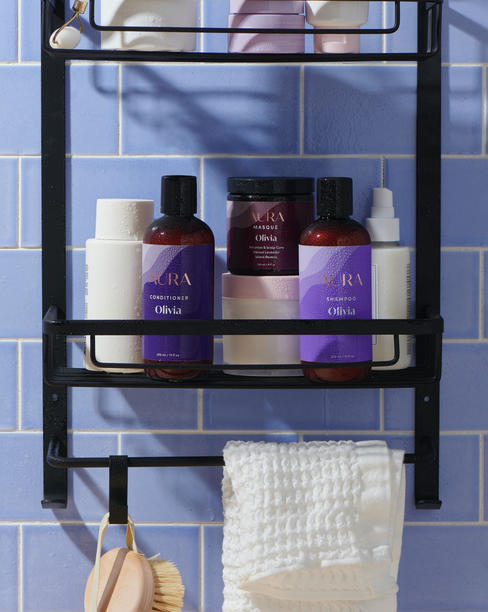 AURA personalized hair care products on shower rack
