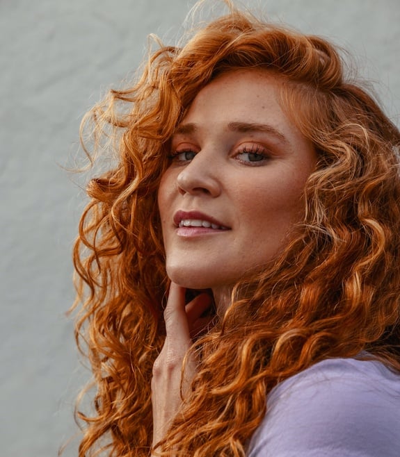 Woman with healthy looking and naturally curly red hair