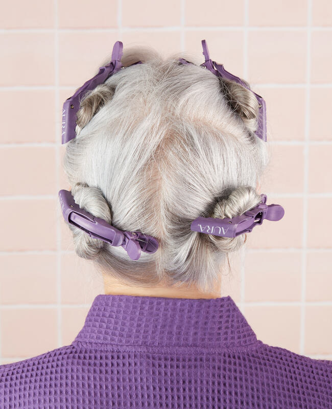 Back of woman's head with clips holding hair up in four sections