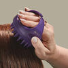 Scalp massager held in a woman's hand thumbnail