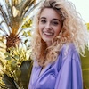 Woman with semi permanent blonde colored curly hair thumbnail